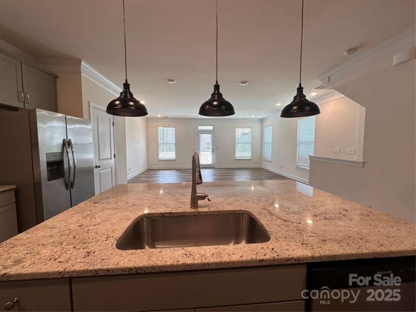 10207 Glenmere Creek Circle, Charlotte, NC 28262.  MLS# CAR4284626, YatesRealty ID 29245. Kitchen island with pedant lights