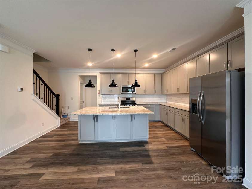10207 Glenmere Creek Circle, Charlotte, NC 28262.  MLS# CAR4284626, YatesRealty ID 29245. Kitchen with living room
