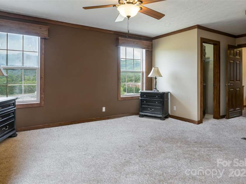 78 Hillcrest Drive, Candler, NC 28715.  MLS# CAR4286565, YatesRealty ID 29251. Primary bed with 2 walk-in closets, carpet is virtual.