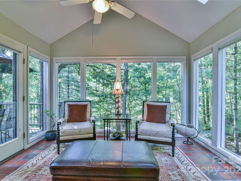 409 North Fork Road, Black Mountain, NC 28711.  MLS# CAR4284708, YatesRealty ID 29252. Keeping room flows into to a light-filled sunroom, that feels like a dream tree house. 