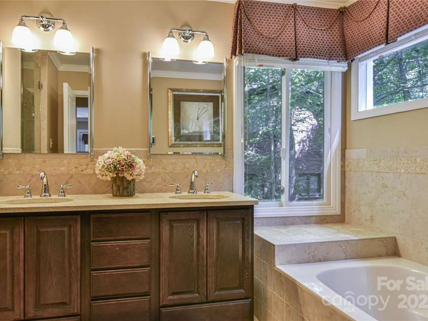 409 North Fork Road, Black Mountain, NC 28711.  MLS# CAR4284708, YatesRealty ID 29252. Luxurious bath with double sinks, soaking tub, and his and hers walk in closets. 
