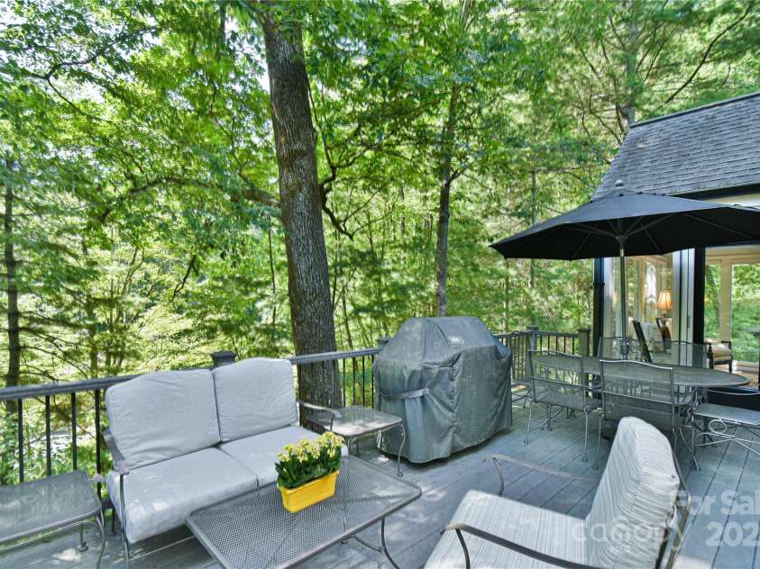 409 North Fork Road, Black Mountain, NC 28711.  MLS# CAR4284708, YatesRealty ID 29252. Main level deck with space for conversation area and outdoor grill with dining. 