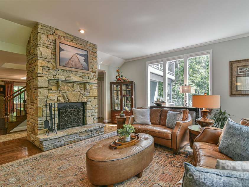 409 North Fork Road, Black Mountain, NC 28711.  MLS# CAR4284708, YatesRealty ID 29252. Main level living room features another floor to ceiling wood burning fireplace. Ample room for a crowd to feel cozy around the fire. 