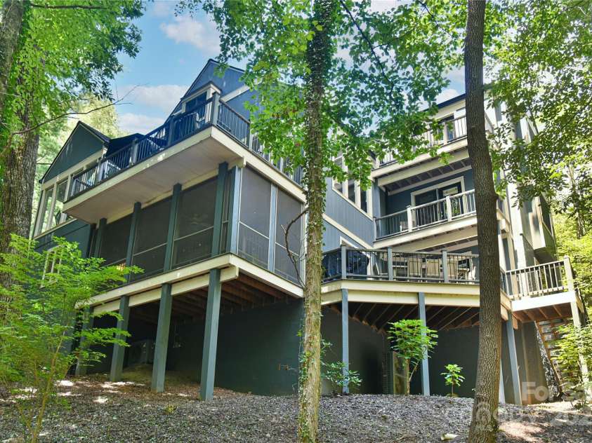 409 North Fork Road, Black Mountain, NC 28711.  MLS# CAR4284708, YatesRealty ID 29252. Nearly as much outdoor living space as indoor living space! Three ensuite bedrooms have private balconies, each common indoor living area opens to an outdoor gathering and dining area. 