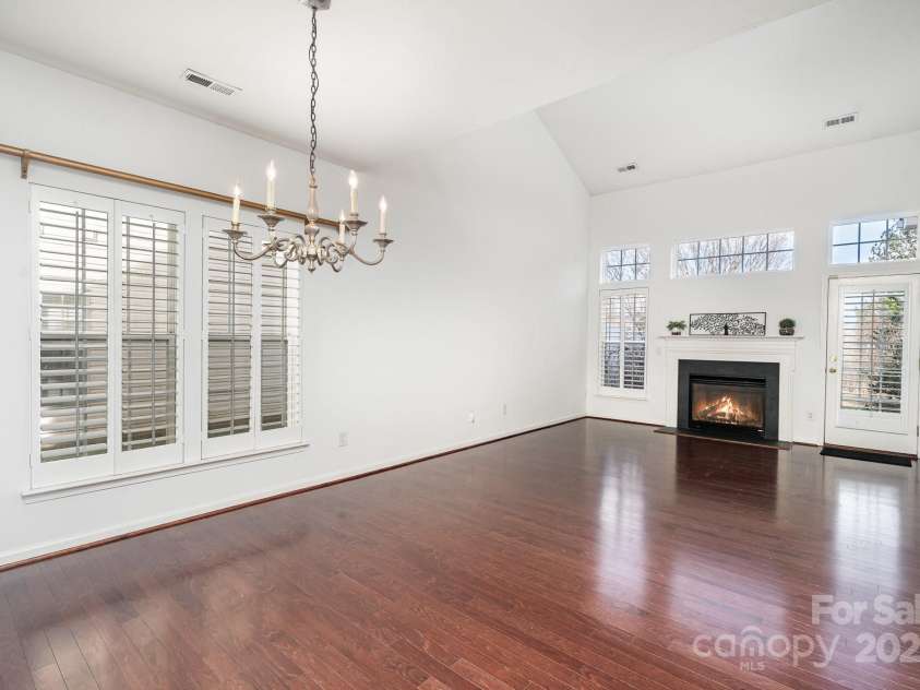 3822 Carl Parmer Drive, Harrisburg, NC 28075.  MLS# CAR4223446, YatesRealty ID 2927. Bright and airy living room basks in natural light.  Plantation shutters throughout