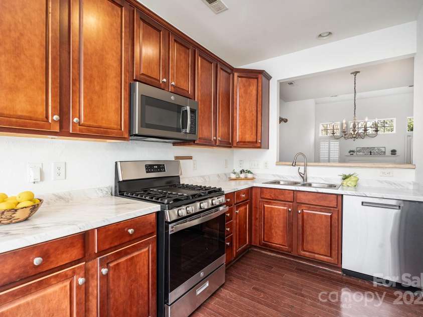 3822 Carl Parmer Drive, Harrisburg, NC 28075.  MLS# CAR4223446, YatesRealty ID 2927. Kitchen has gas range and 42