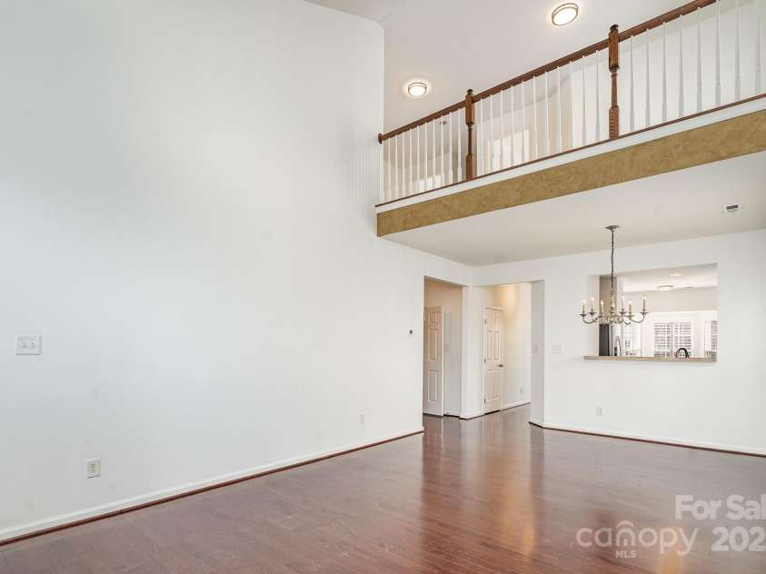 3822 Carl Parmer Drive, Harrisburg, NC 28075.  MLS# CAR4223446, YatesRealty ID 2927. View from living room back towards kitchen.  Open to loft above