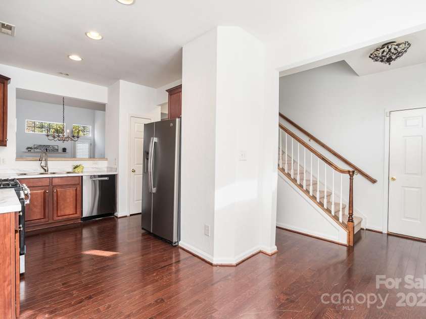 3822 Carl Parmer Drive, Harrisburg, NC 28075.  MLS# CAR4223446, YatesRealty ID 2927. View of kitchen from bay window showing stairs and view to dining area and living room