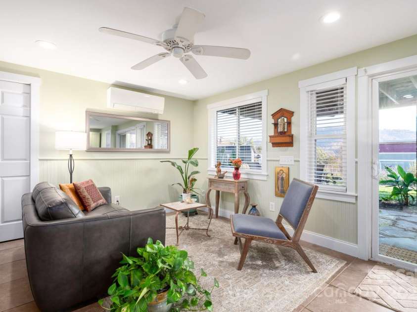 31 Skyland Circle, Asheville, NC 28804.  MLS# CAR4284823, YatesRealty ID 29278. Large living room in the lower level (again, former tenant furnishings)