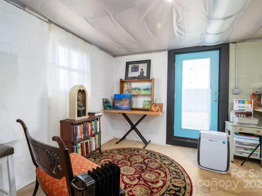 31 Skyland Circle, Asheville, NC 28804.  MLS# CAR4284823, YatesRealty ID 29278. Unfinished section of the basement previously used as an art studio