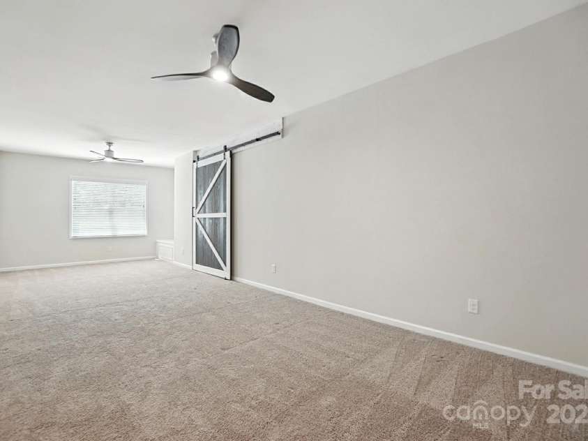 4128 La Crema Drive, Charlotte, NC 28214.  MLS# CAR4284944, YatesRealty ID 29298. Spacious bonus/bedroom with barn door