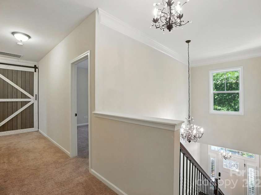 4128 La Crema Drive, Charlotte, NC 28214.  MLS# CAR4284944, YatesRealty ID 29298. The upper level provides incredible versatility with a massive bonus room, perfect for a spacious home office, an additional bedroom, or a vibrant recreation space, alongside 2 comfortable secondary bedrooms and full b