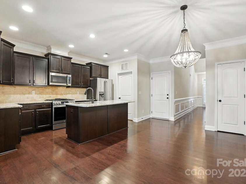 4128 La Crema Drive, Charlotte, NC 28214.  MLS# CAR4284944, YatesRealty ID 29298. Unleash your inner chef in the dream kitchen, featuring sleek stainless steel appliances, gleaming granite countertops, and a functional center island – perfect for both meal prep and casual gatherings