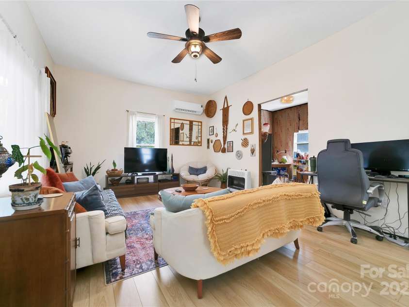 89 Whitmire Street, Brevard, NC 28712.  MLS# CAR4281325, YatesRealty ID 29327. Spacious and full of character, this living room offers a welcoming feel with an easy flow right into the kitchen perfect for gatherings, quiet evenings, or just enjoying the simple comforts of home.