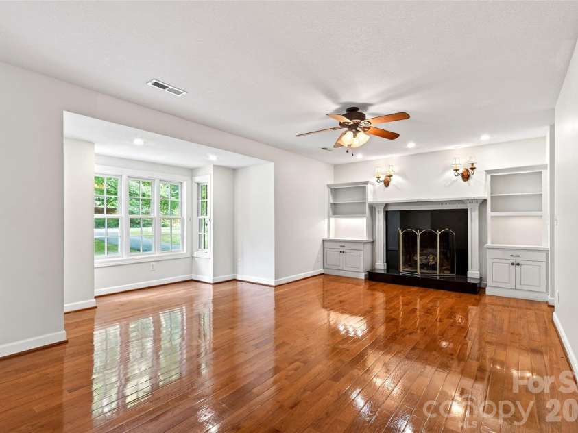104 Valley Vista Drive, Black Mountain, NC 28711.  MLS# CAR4388162, YatesRealty ID 29333. Den with gas fireplace and beautiful view of the front yard,