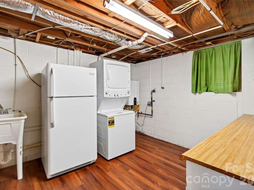 104 Valley Vista Drive, Black Mountain, NC 28711.  MLS# CAR4388162, YatesRealty ID 29333. Great flex space with stackable washer/dryer, fridge, laundry sink and folding table