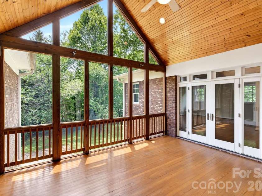 104 Valley Vista Drive, Black Mountain, NC 28711.  MLS# CAR4388162, YatesRealty ID 29333. Sunporch located off of living room, access to primary suite and kitchen.