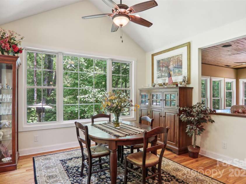 398 Falling Leaves Lane, Hendersonville, NC 28792.  MLS# CAR4267350, YatesRealty ID 29335. Dining area with view opening to sunroom