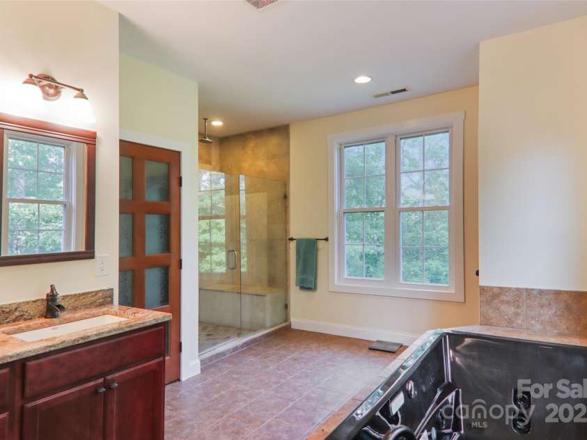 398 Falling Leaves Lane, Hendersonville, NC 28792.  MLS# CAR4267350, YatesRealty ID 29335. Primary bathroom with tub & walk--in shower
