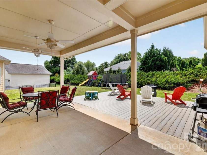 10585 Sweethaven Lane, Harrisburg, NC 28075.  MLS# CAR4356507, YatesRealty ID 29338. Outside Covered Patio with a connecting Deck extension. 