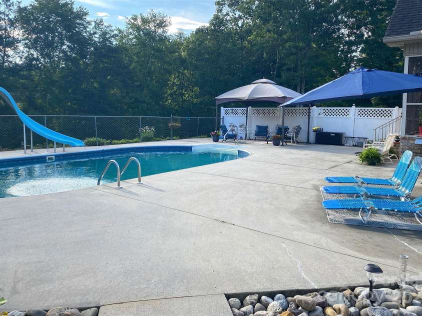142 Windsor Drive, Taylorsville, NC 28681.  MLS# CAR4283783, YatesRealty ID 29339. Plenty of space for lounging on the pool deck