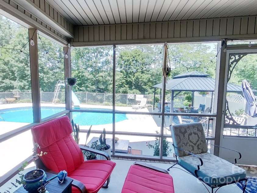 142 Windsor Drive, Taylorsville, NC 28681.  MLS# CAR4283783, YatesRealty ID 29339. Screened Porch Overlooking the Pool