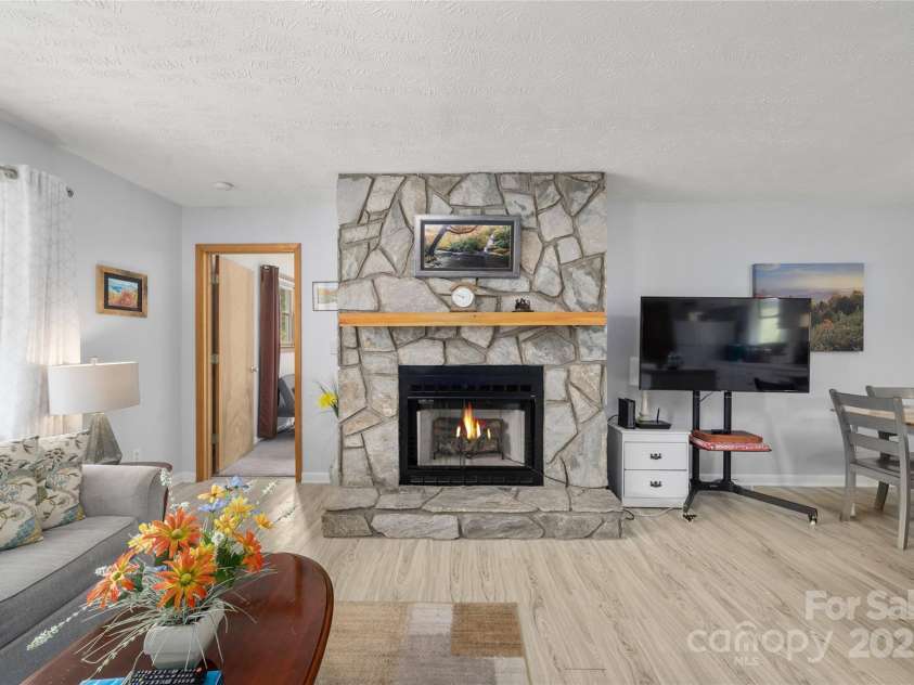 262 Lewis Lane, Maggie Valley, NC 28751.  MLS# CAR4265757, YatesRealty ID 29347. Fireplace at the center of the home is wood burning