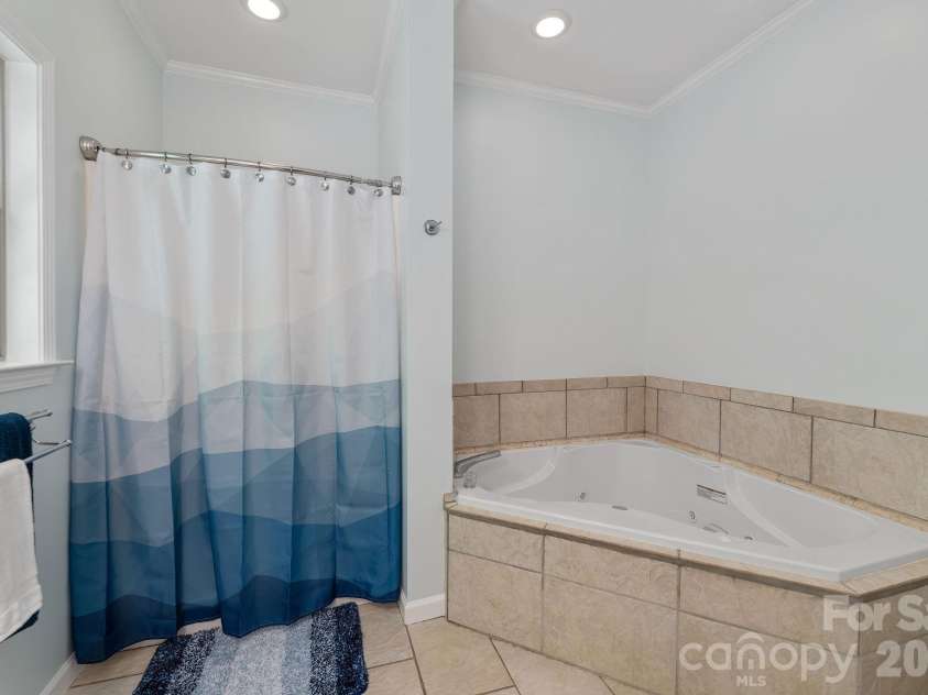 174 deep woods Trail, Canton, NC 28716.  MLS# CAR4378961, YatesRealty ID 29357. Ensuite bathroom with shower and bath. 