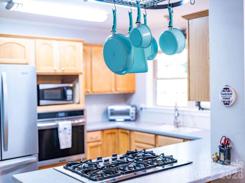 174 deep woods Trail, Canton, NC 28716.  MLS# CAR4378961, YatesRealty ID 29357. Gas stove open to  dining area.