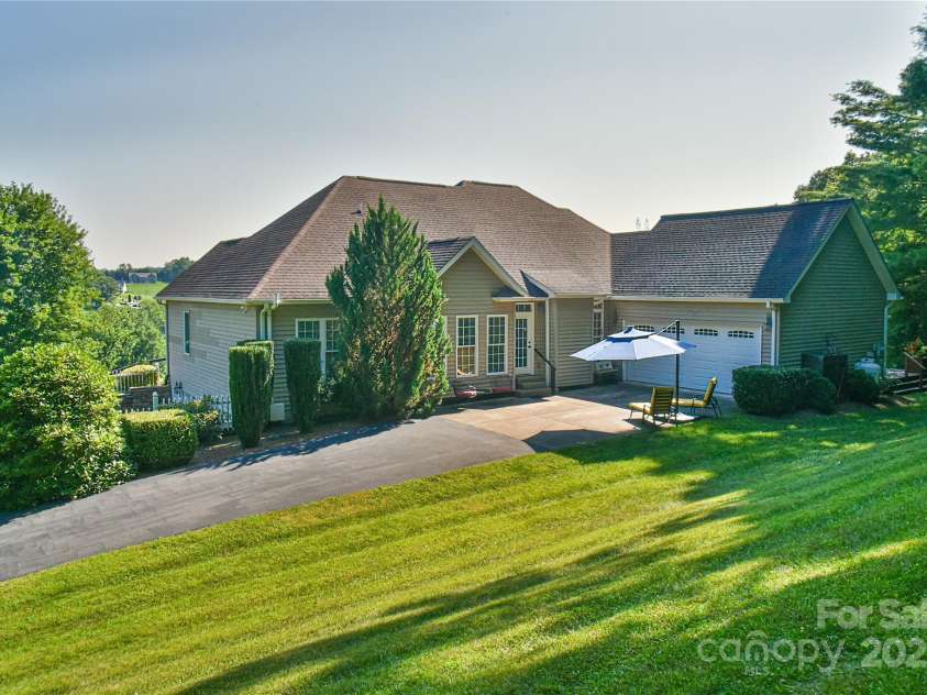 110 Michael Court, Leicester, NC 28748.  MLS# CAR4283846, YatesRealty ID 29373. Great view from the back yard looking at the back of the house and upper 2 car garage.