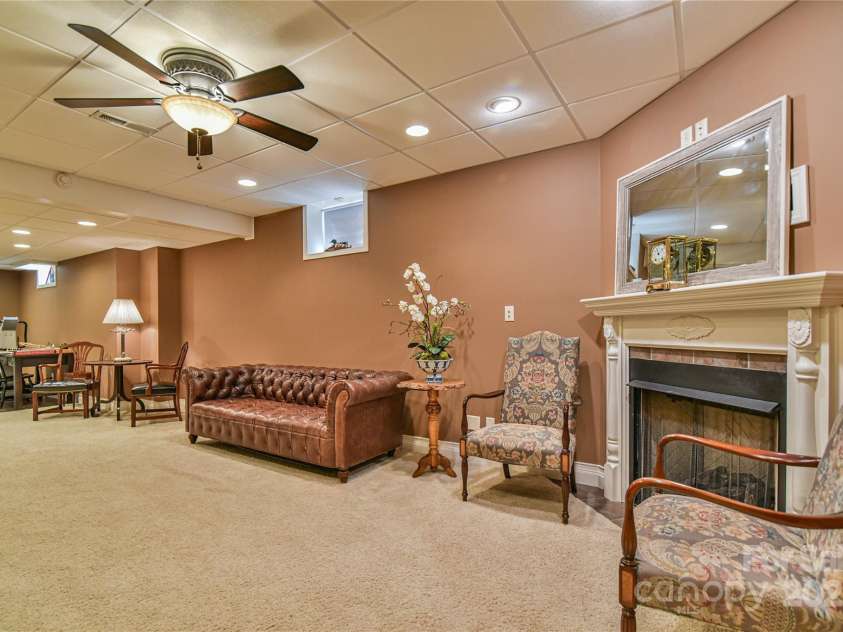 110 Michael Court, Leicester, NC 28748.  MLS# CAR4283846, YatesRealty ID 29373. Lower level entertaining area or could be a living room for a future airbnb, in-law or visitors on college break. With a gas fireplace.