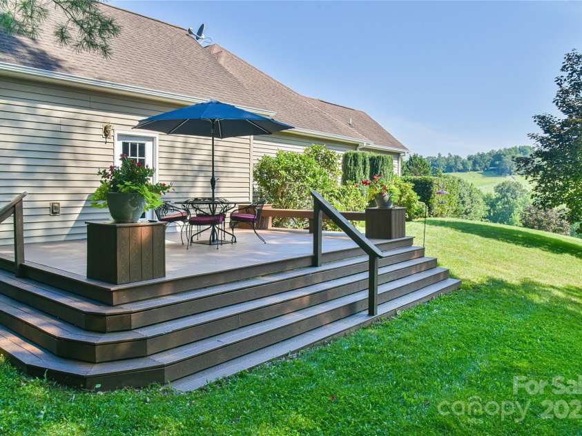 110 Michael Court, Leicester, NC 28748.  MLS# CAR4283846, YatesRealty ID 29373. Side entertaining deck location on the main level located just off the upper 2 car garage offering privacy and shade.