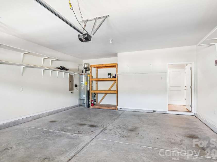 128 Van Gogh Trail, Mount Holly, NC 28120.  MLS# CAR4387655, YatesRealty ID 29376. Two car garage has extra storage racks and shelving