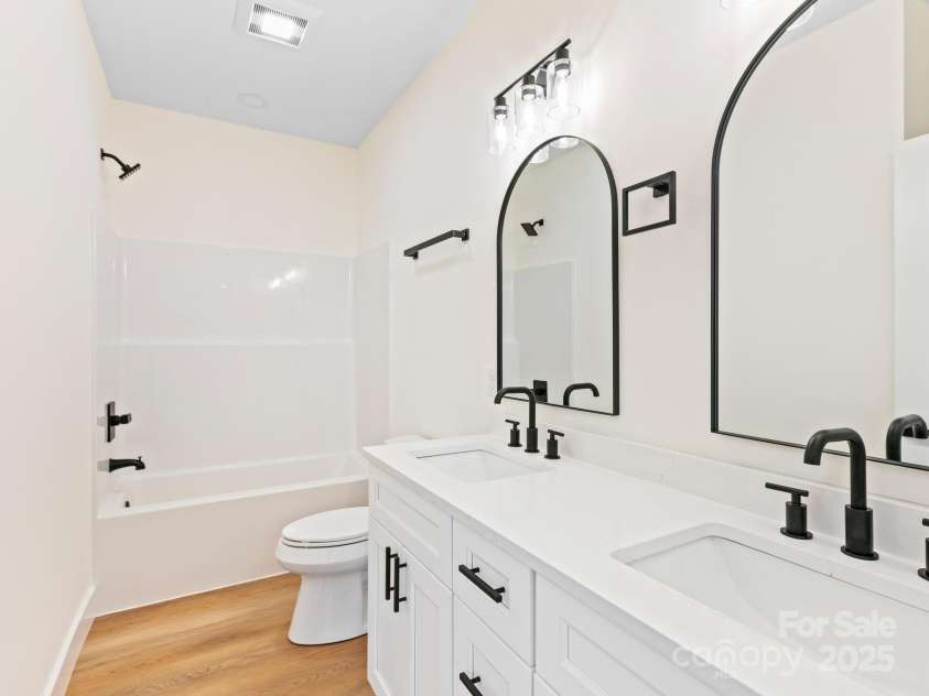 169 Vineyard Village Drive, Old Fort, NC 28762.  MLS# CAR4268925, YatesRealty ID 29376. Guest hall bath also features dual sinks, quartz counters and black fixtures & hardware. 