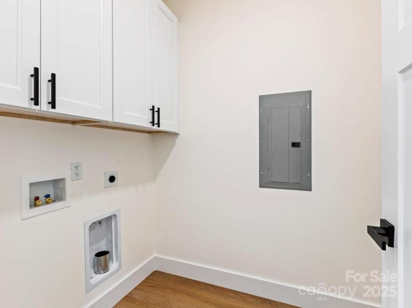 169 Vineyard Village Drive, Old Fort, NC 28762.  MLS# CAR4268925, YatesRealty ID 29376. Laundry room comes with cabinets for storage and space for a side by side washer and dryer