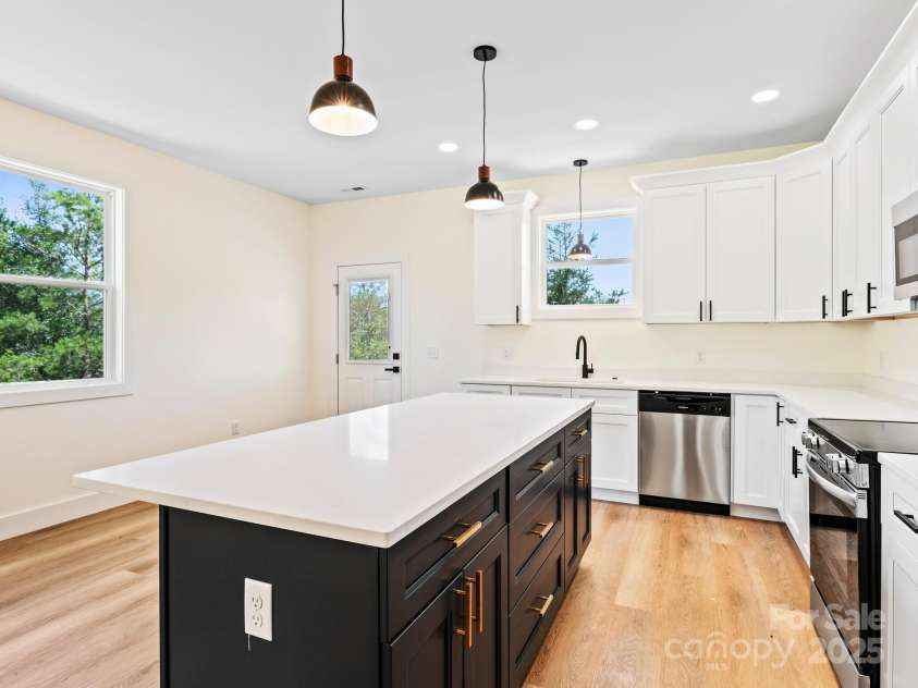 169 Vineyard Village Drive, Old Fort, NC 28762.  MLS# CAR4268925, YatesRealty ID 29376. Quartz counters and contrasting kitchen island make the kitchen pop. 