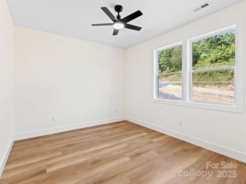 169 Vineyard Village Drive, Old Fort, NC 28762.  MLS# CAR4268925, YatesRealty ID 29376. The larger of the two guest rooms is down the hall from the primary giving overnight guest or family space.