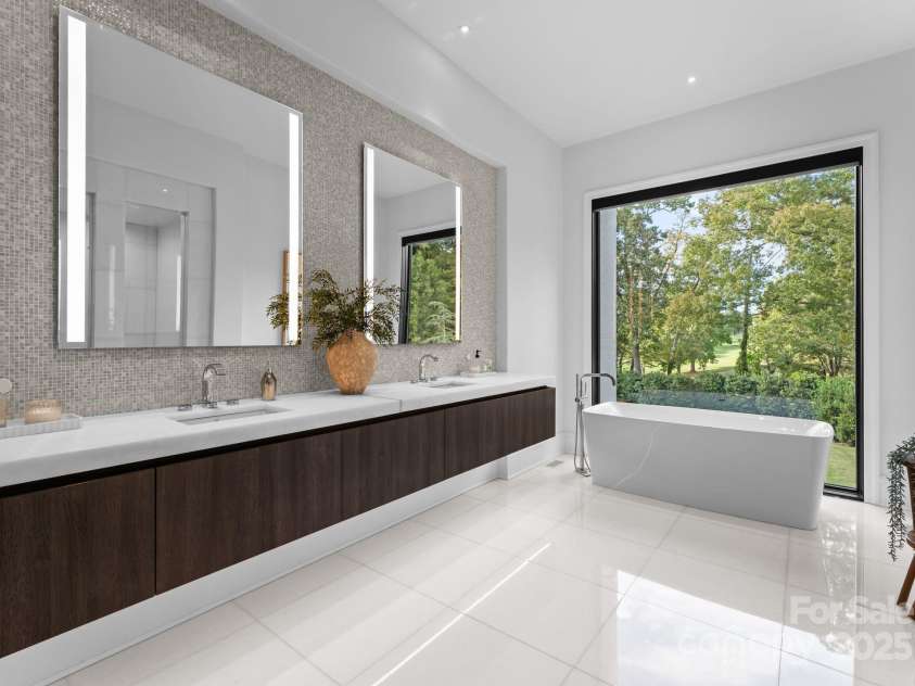 2116 Woodhaven Road, Charlotte, NC 28211.  MLS# CAR4186147, YatesRealty ID 2938. Primary bathroom with heated floors and modern soaking tub overlooking private backyard