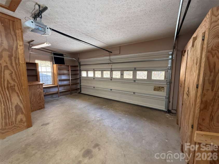 215 Pinellas Lane, Waynesville, NC 28785.  MLS# CAR4351510, YatesRealty ID 2941. Large garage with work bench