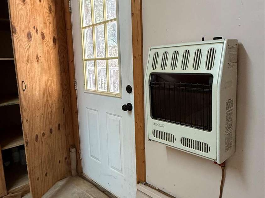 215 Pinellas Lane, Waynesville, NC 28785.  MLS# CAR4351510, YatesRealty ID 2941. Propane wall heater in Garage