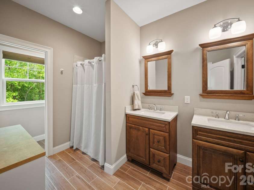 22 Asher Lane, Arden, NC 28704.  MLS# CAR4380408, YatesRealty ID 29433. Ensuite bathroom with tile floor