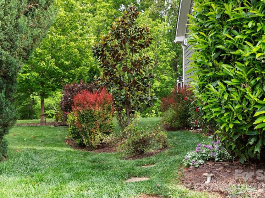 22 Asher Lane, Arden, NC 28704.  MLS# CAR4380408, YatesRealty ID 29433. Lush landscaping