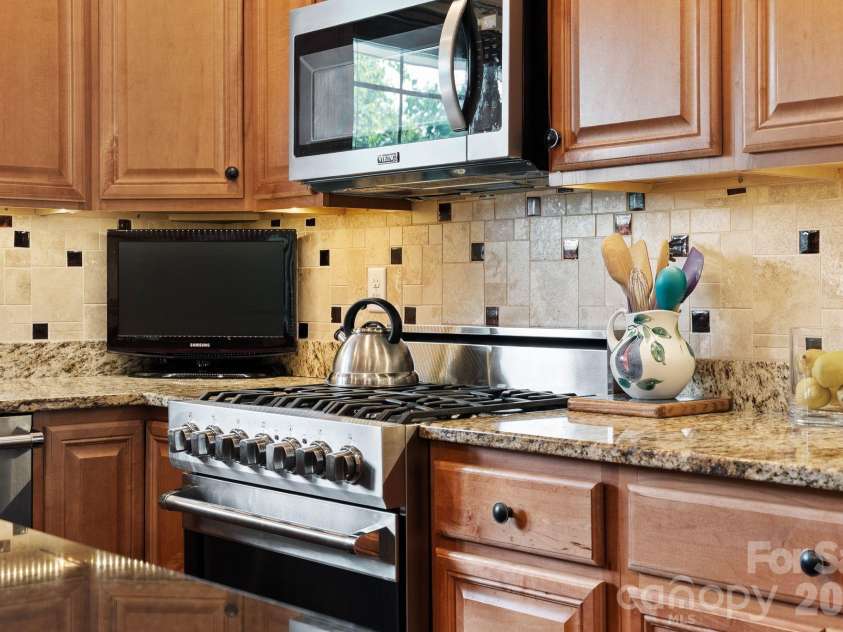 22 Asher Lane, Arden, NC 28704.  MLS# CAR4380408, YatesRealty ID 29433. Tile backsplash and gas range