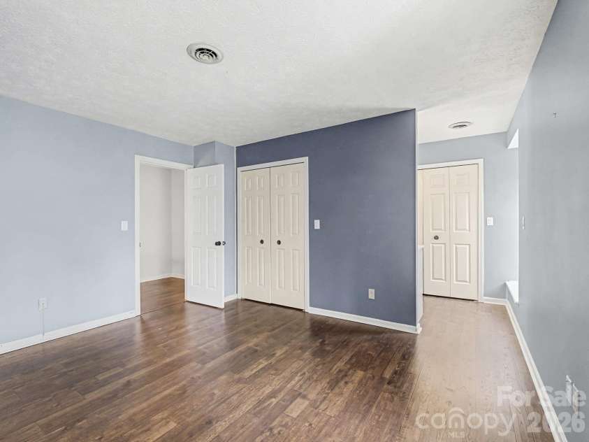 1409 Kensington Road, Hendersonville, NC 28791.  MLS# CAR4345772, YatesRealty ID 2946. Large Primary Bedroom, view 2, looking towards closets & en suite bathroom