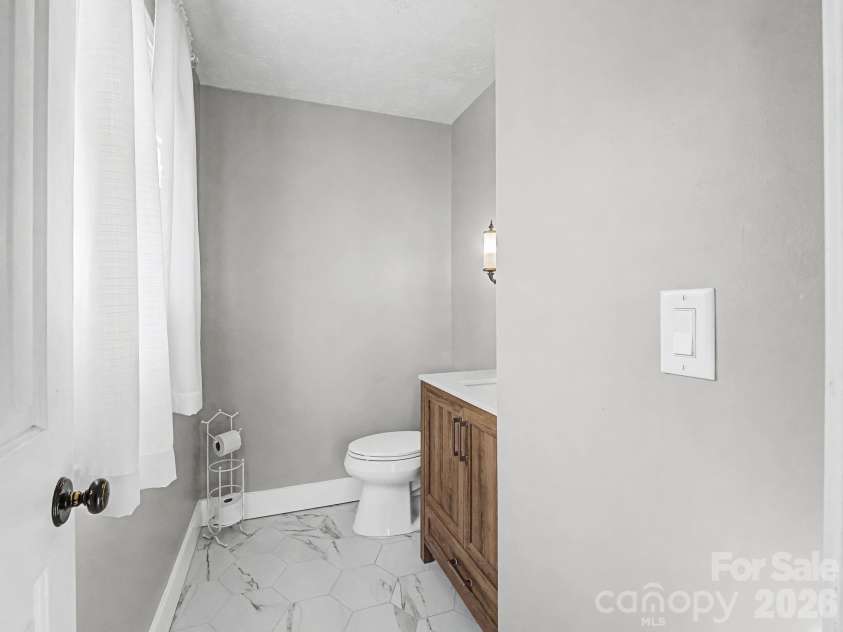 1409 Kensington Road, Hendersonville, NC 28791.  MLS# CAR4345772, YatesRealty ID 2946. Powder room, off of hallway at front entrance