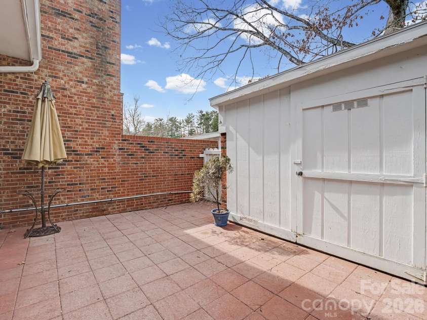 1409 Kensington Road, Hendersonville, NC 28791.  MLS# CAR4345772, YatesRealty ID 2946. Private patio with large storage shed incorporated 