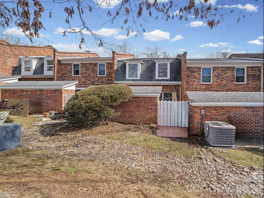1409 Kensington Road, Hendersonville, NC 28791.  MLS# CAR4345772, YatesRealty ID 2946. Rear of view of home & private patio area