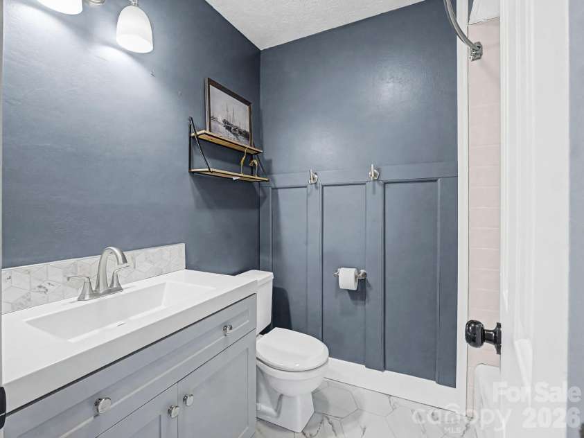 1409 Kensington Road, Hendersonville, NC 28791.  MLS# CAR4345772, YatesRealty ID 2946. Upper level Guest Bath, beautiful tiled floor & shower