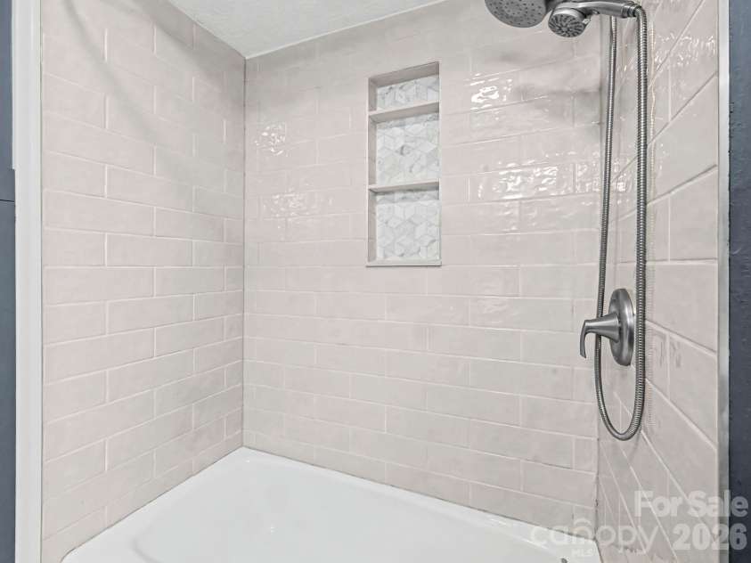 1409 Kensington Road, Hendersonville, NC 28791.  MLS# CAR4345772, YatesRealty ID 2946. Upper level Guest Bath, features beautiful tiled shower