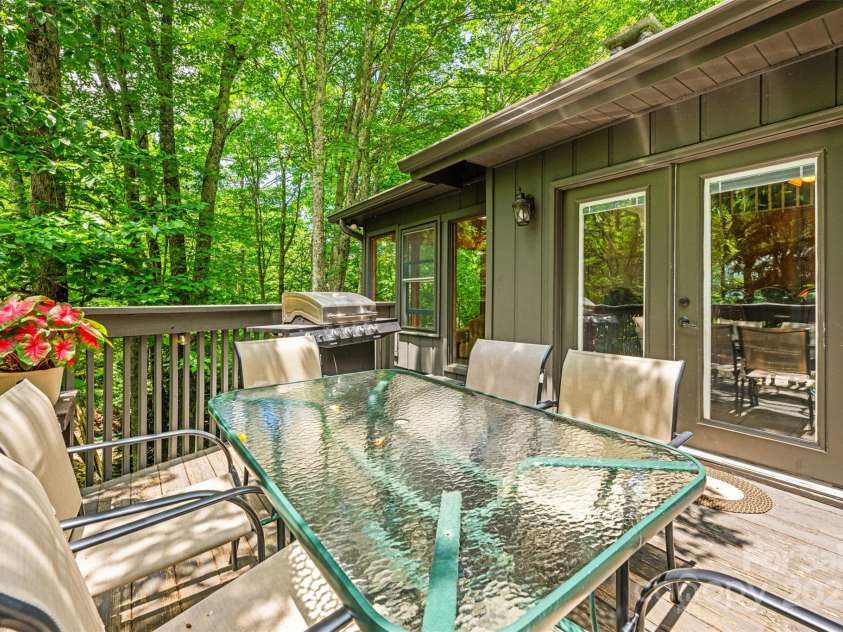 321 Charter Hills Road, Beech Mountain, NC 28604.  MLS# CAR4276469, YatesRealty ID 29495. Dining porch overlooking creek